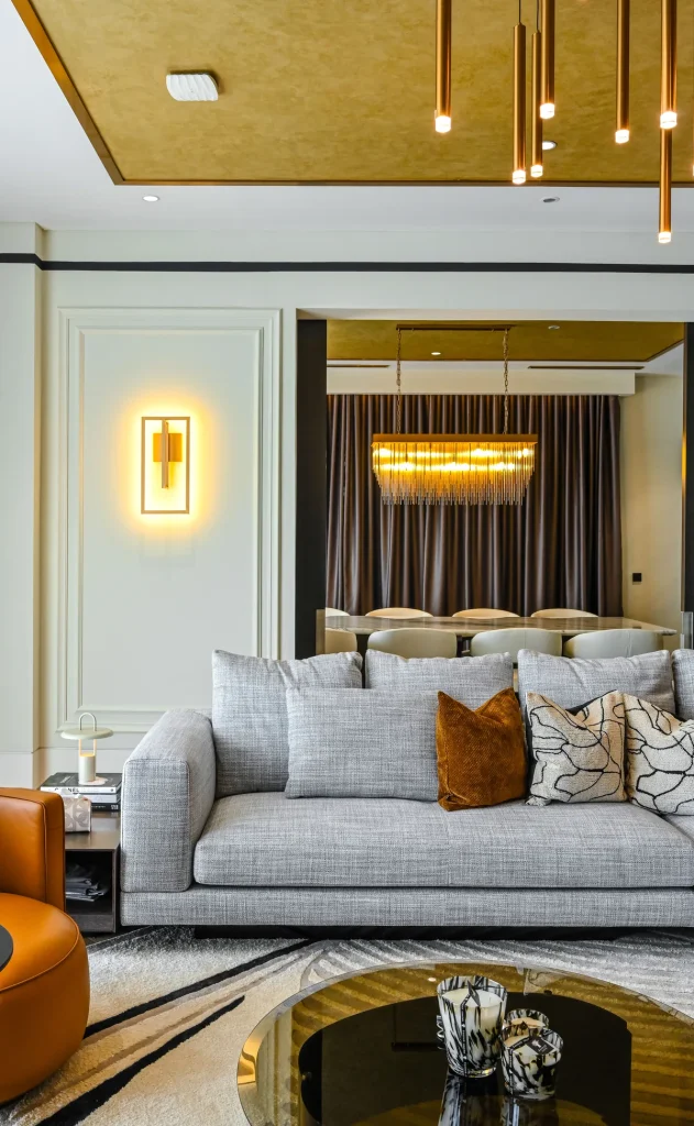 Luxury living and dining space with gold-leaf ceiling, layered lighting and bespoke furniture at Aira Residence, Kuala Lumpur, by Blaine Robert Design