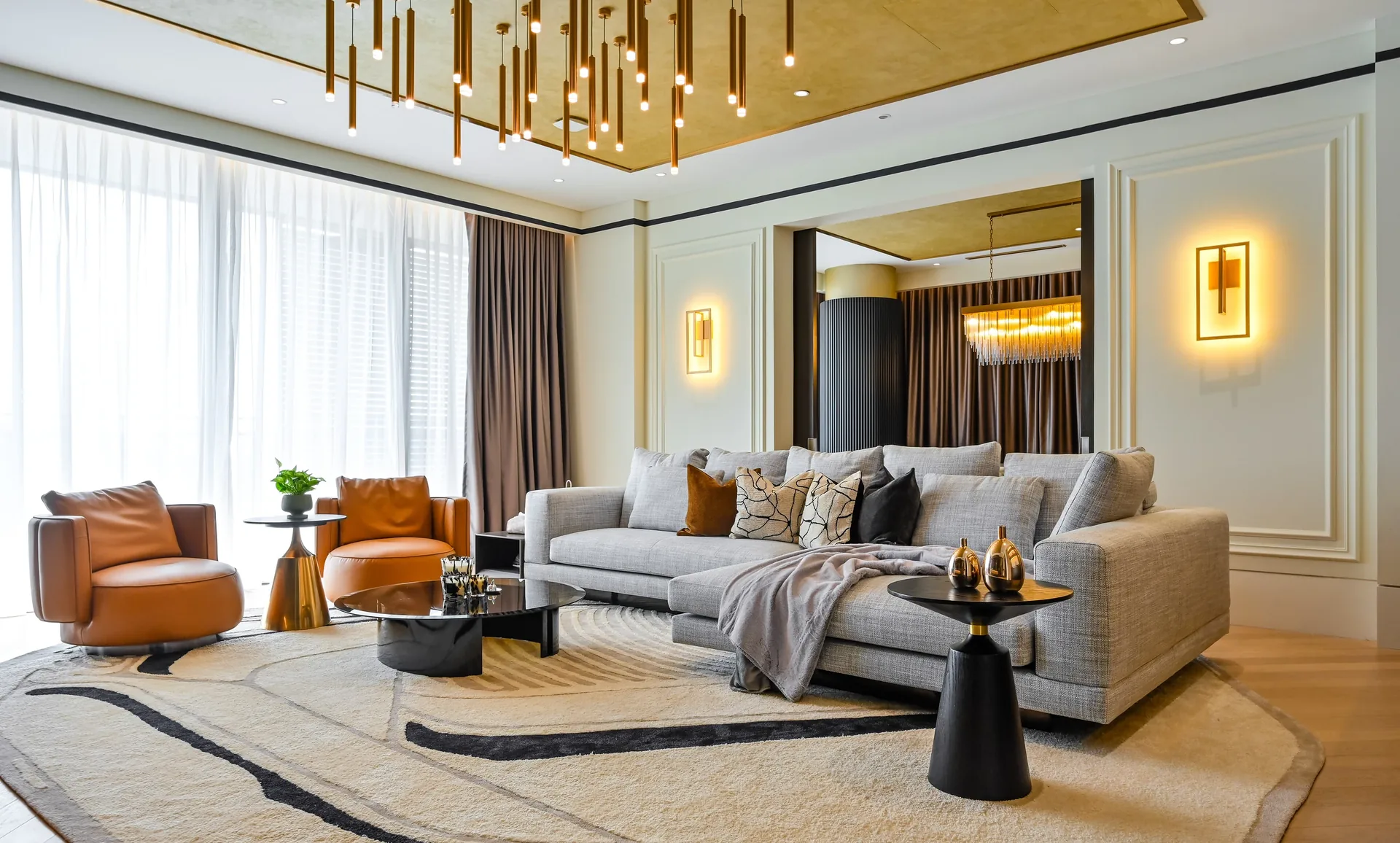 Home interior design in Malaysia — warm contemporary living room with gold-leaf ceiling detail, Aira Residence, Kuala Lumpur