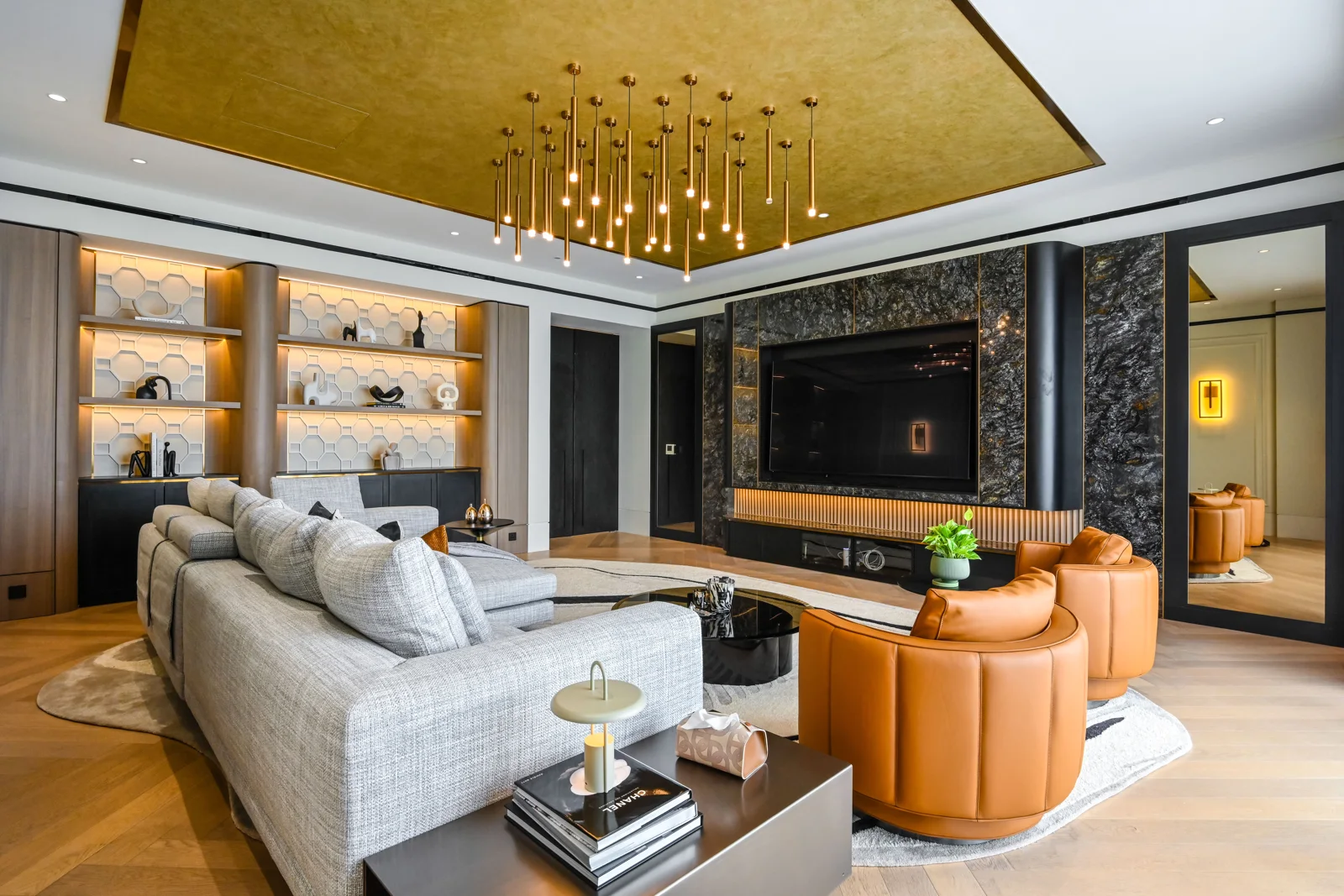 Contemporary living room with a stone television wall and layered textures, Aira Residence, Kuala Lumpur