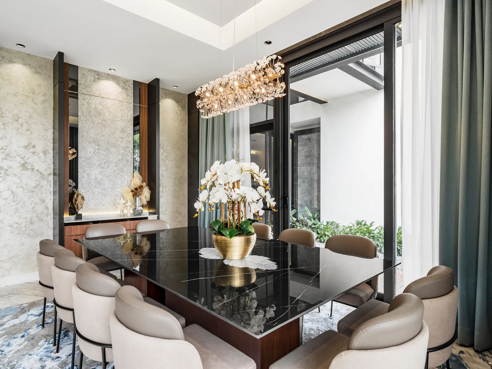 Dining area with a black stone table beside a full-height window in the Kelana Jaya bungalow