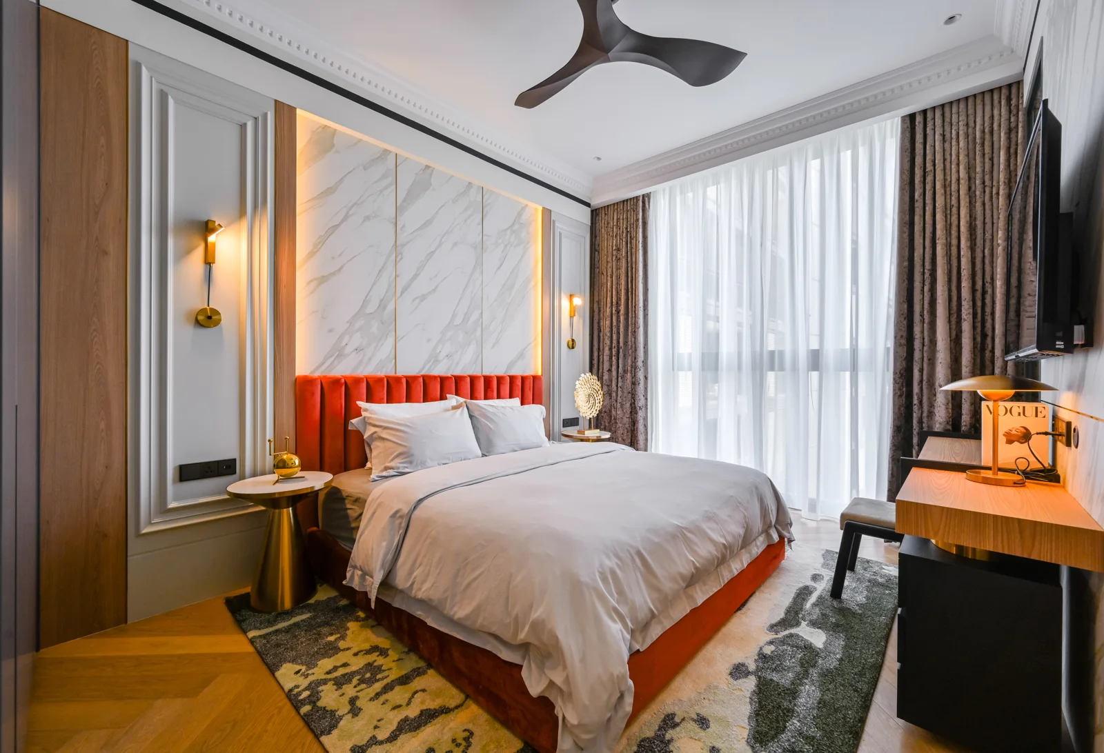 Master bedroom with a marble headboard wall and a bold accent colour, Aira Residence