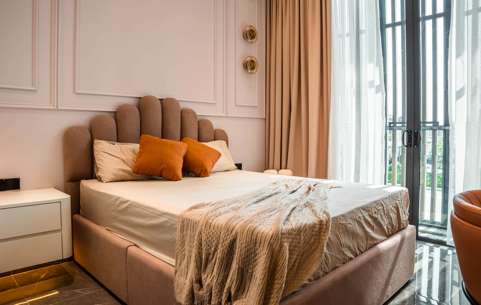 Curved headboard and earthy terracotta tones in a bedroom at Setia Marina One, Cyberjaya