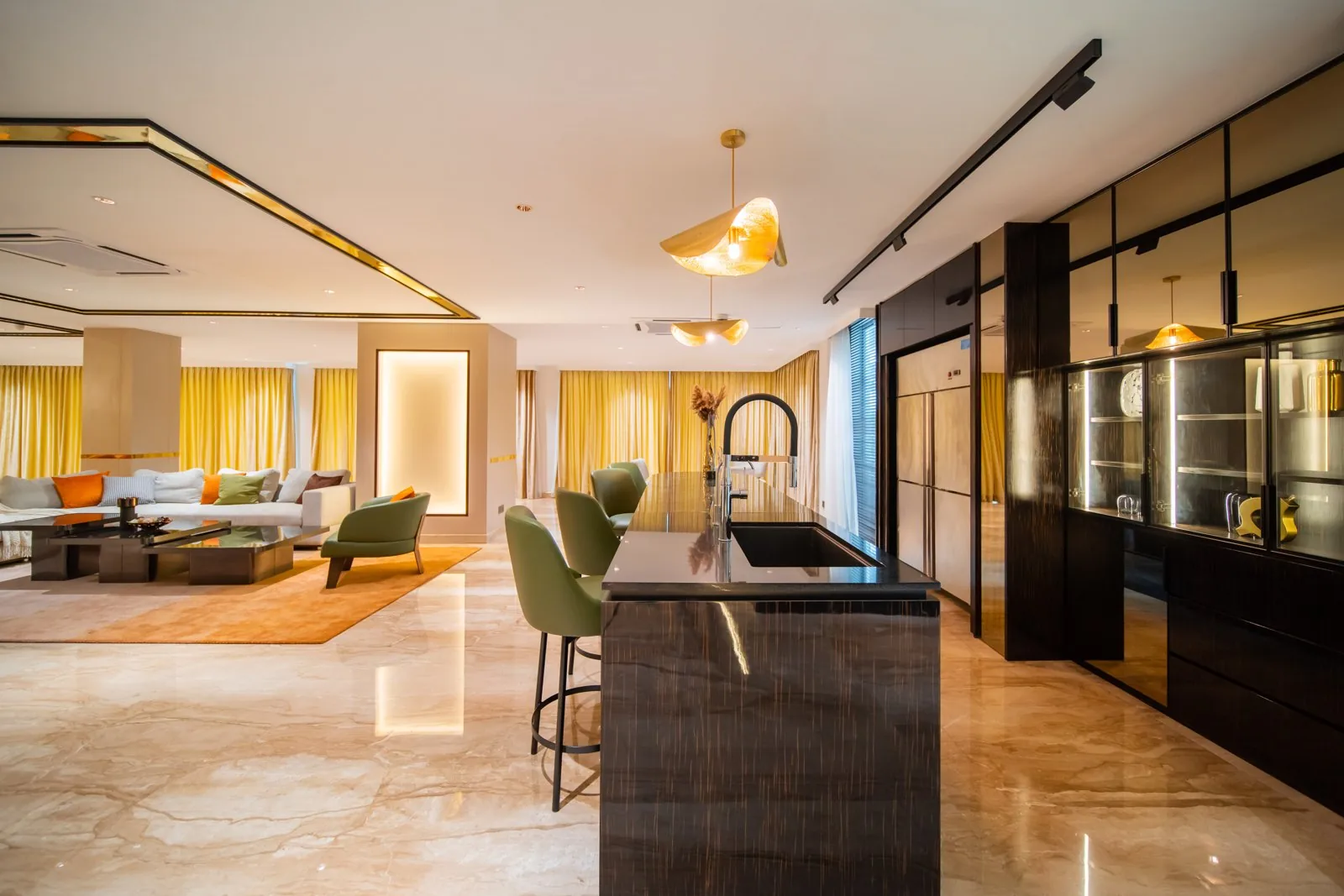 Open kitchen island with a sink facing the living room in the Bangsar Bungalow at Bukit Pantai, Kuala Lumpur, by Blaine Robert Design