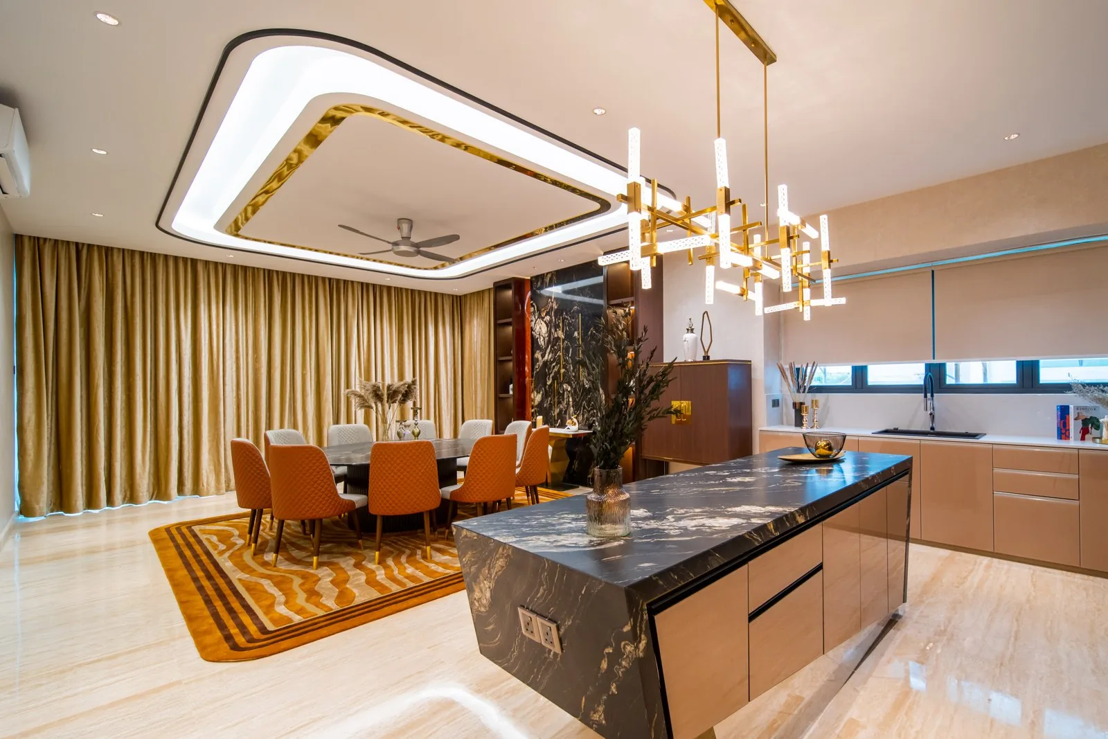 Black stone kitchen island between the open kitchen and the dining table in a Bangsar bungalow, designed and built by Blaine Robert Design