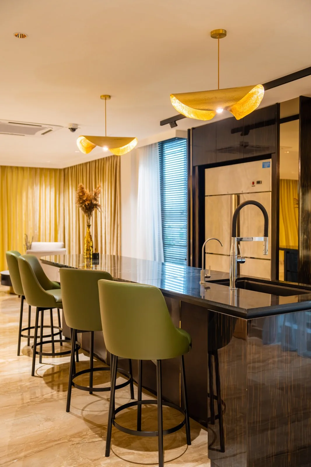 Open kitchen island with bar stools and tall cabinets behind in a Bangsar bungalow, by Blaine Robert Design