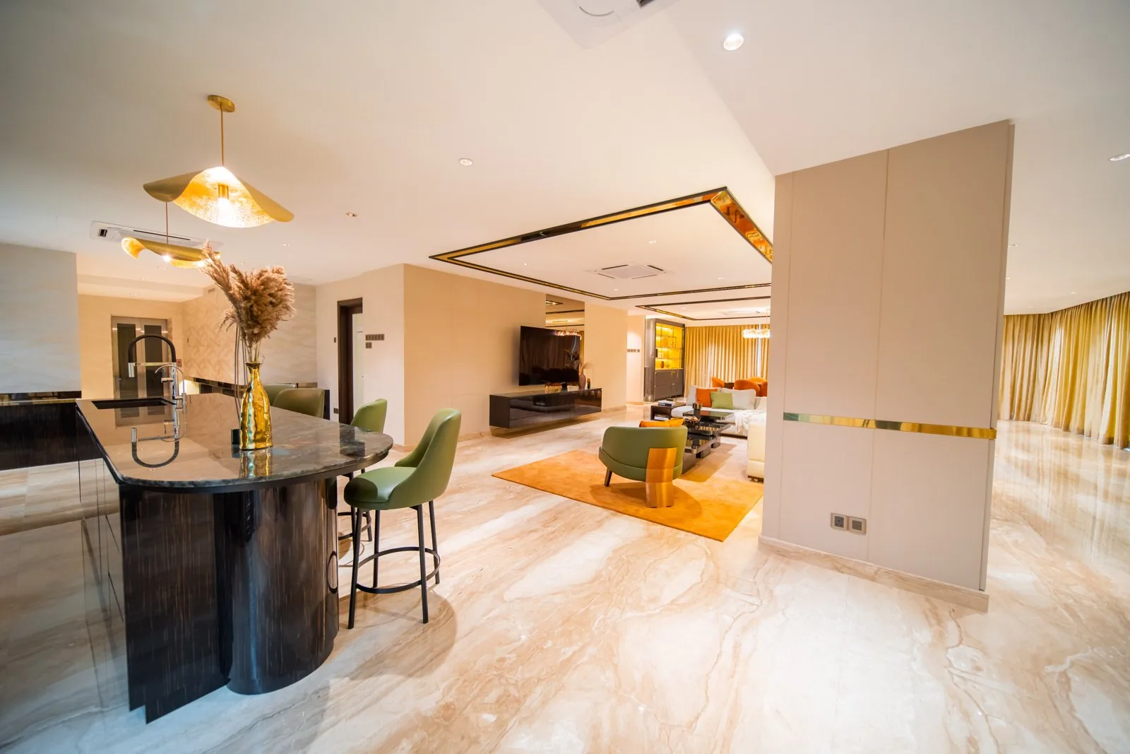 Curved kitchen island and a tall panel screening the living room in a Bangsar bungalow open plan, by Blaine Robert Design