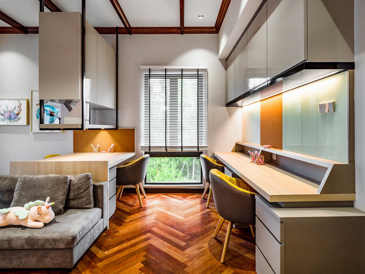 Built-in desk feature wall zoning a family corner in an open-plan Malaysian home