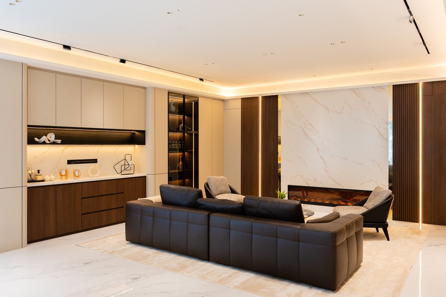 Bookmatched marble feature wall carrying the television in the living room at Park Regent, Desa ParkCity