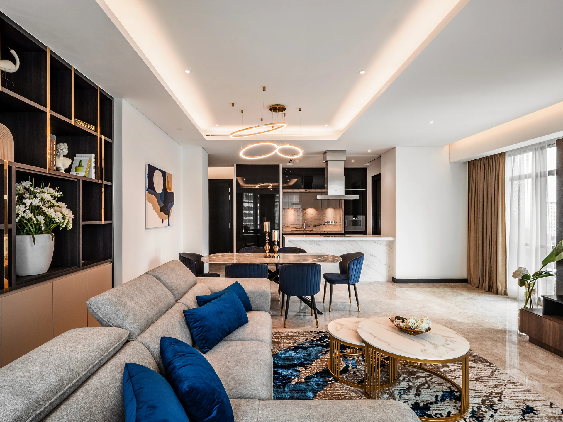 Living hall flowing into the dining area and open kitchen at the Ritz-Carlton Residences, Kuala Lumpur.