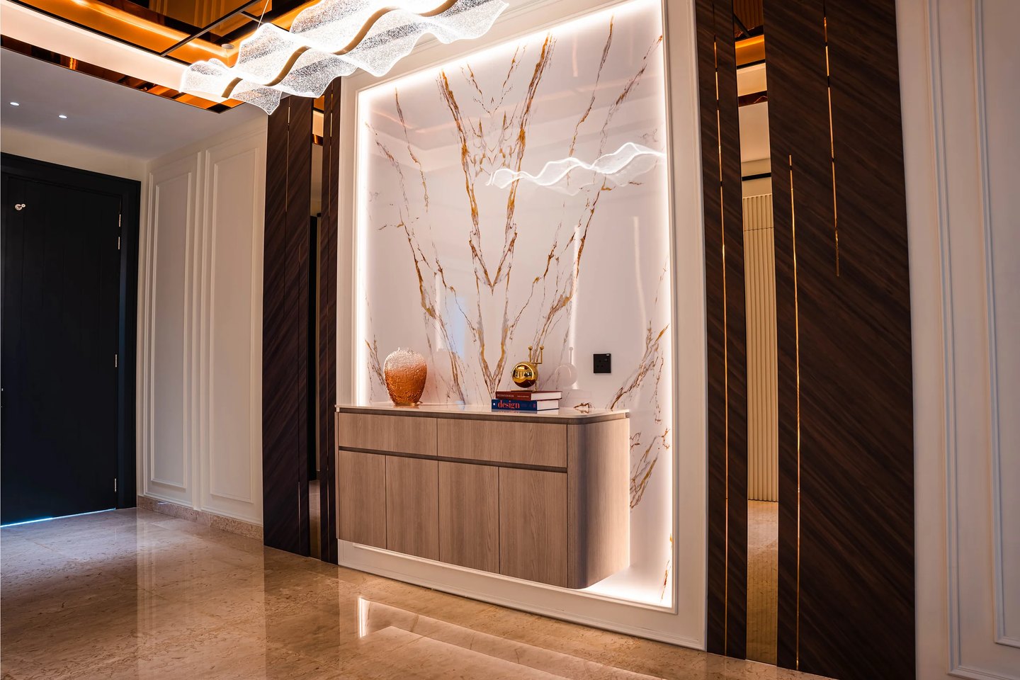 Backlit marble feature wall with gold veining behind a foyer console at Setia Marina One, Cyberjaya