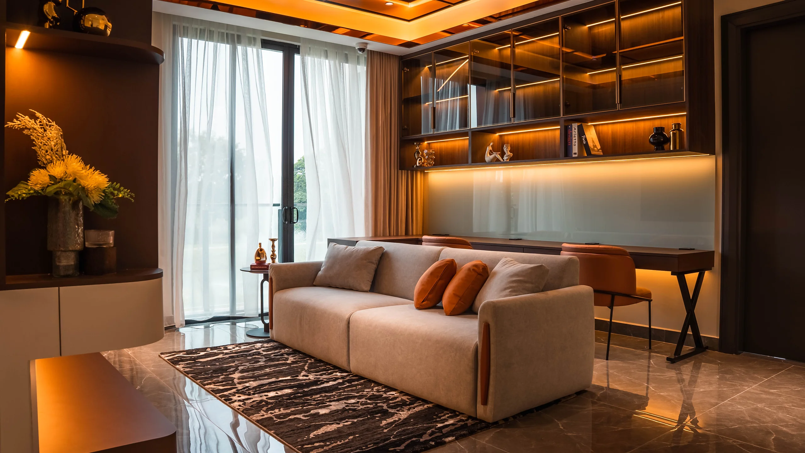 Backlit built-in shelving and a study desk lining the lounge wall at Setia Marina One, Cyberjaya.