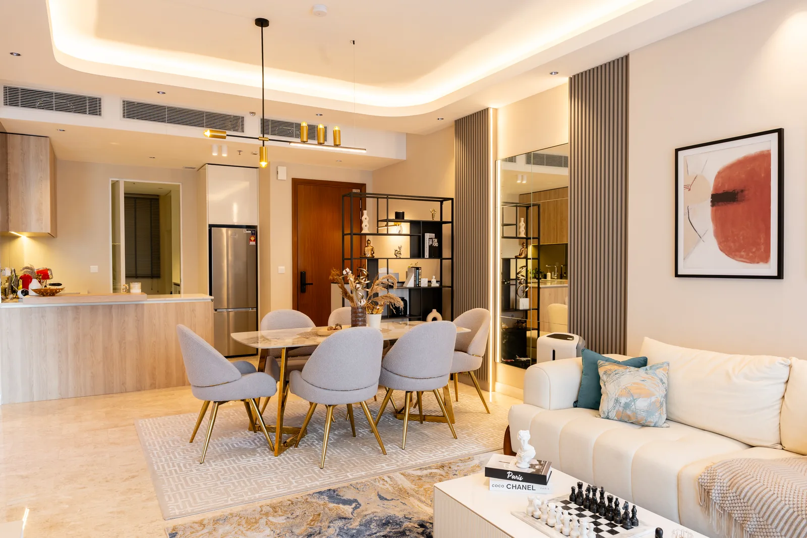 Condo kitchen with a light timber breakfast bar facing the dining table at TRX Residences, Kuala Lumpur