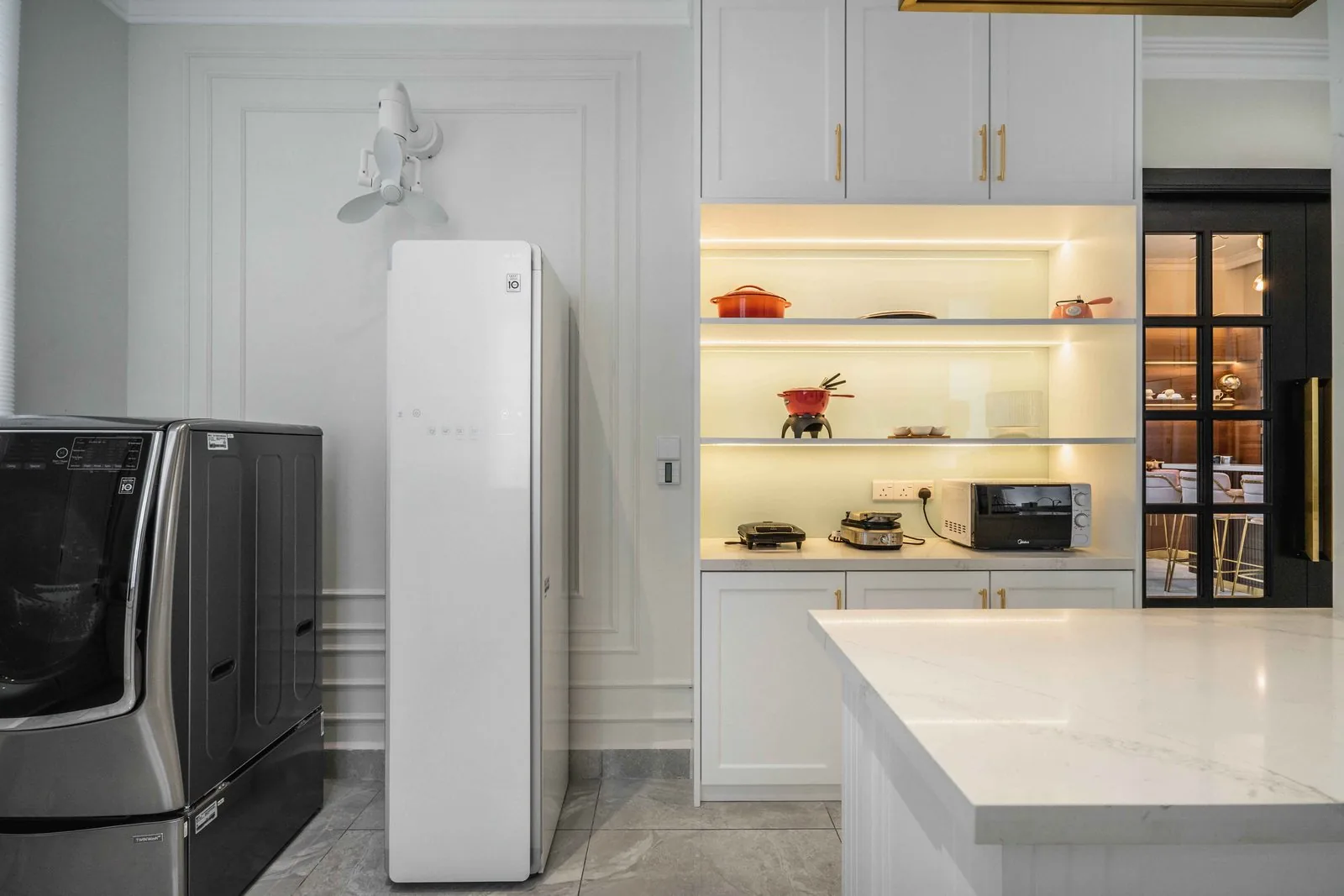 Wet kitchen with lit open shelving, white cabinets and a tall white appliance at EcoSpring Villa, Johor Bahru