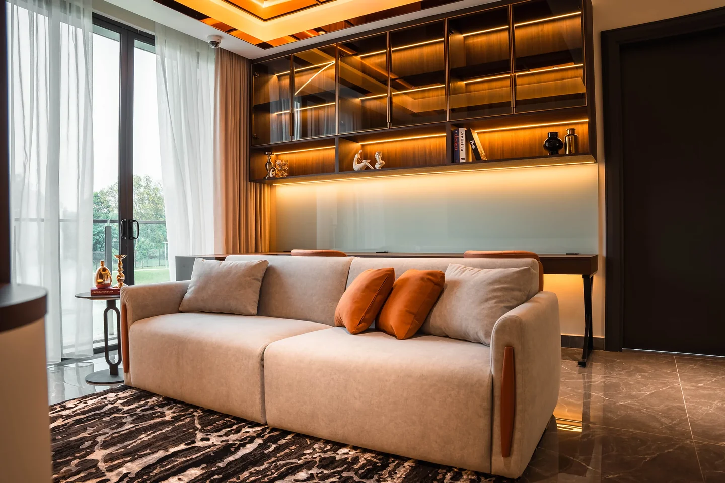 Compact upstairs lounge with a two-seat sofa, built-in shelving and a small round side table, Setia Marina One bungalow