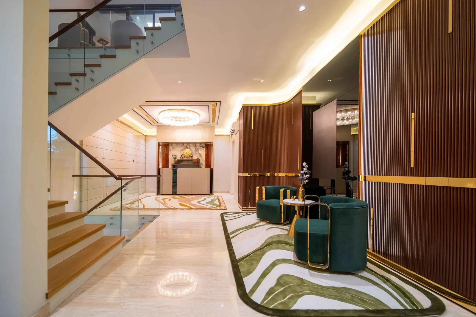 Timber stair treads and a glass balustrade in the foyer of a Bangsar bungalow