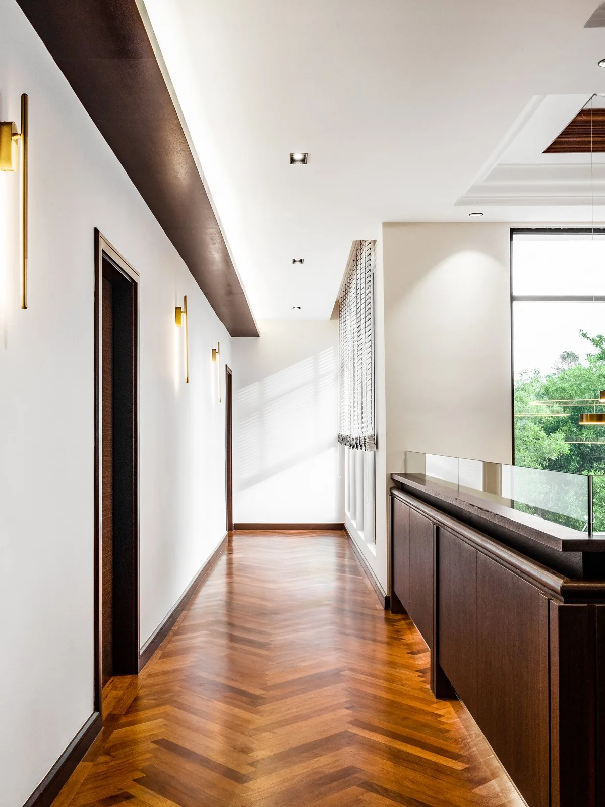 Upper landing corridor with a glass balustrade at the East Coast Villa, Terengganu