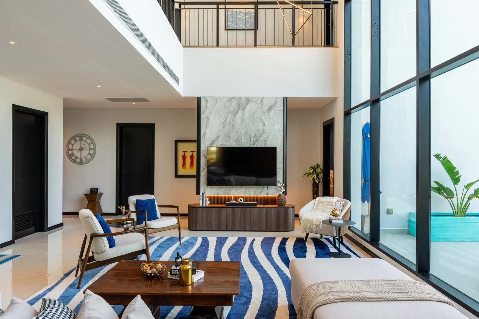 Double-height living area seen from a different angle, with the upper gallery at Quayside Villa