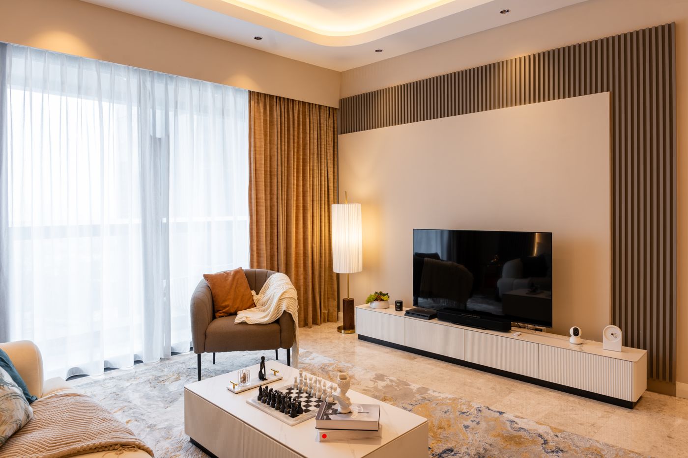 Living area with timber TV wall at TRX Residence, Kuala Lumpur