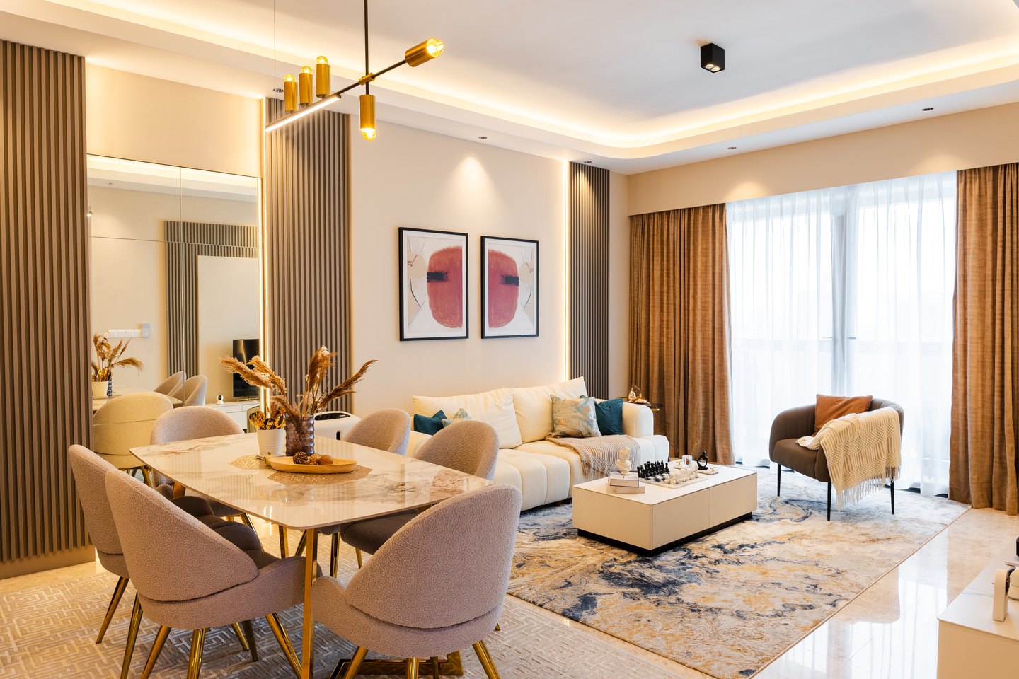 Fluted panelling with mirror inlays stretching a compact living and dining space at TRX Residence, Kuala Lumpur
