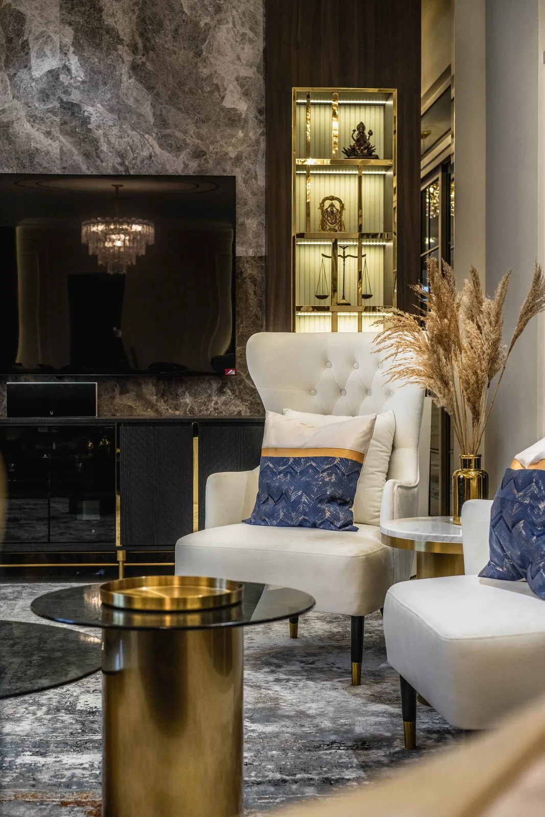 Lit display niche with glass shelves beside the marble TV wall at EcoSpring