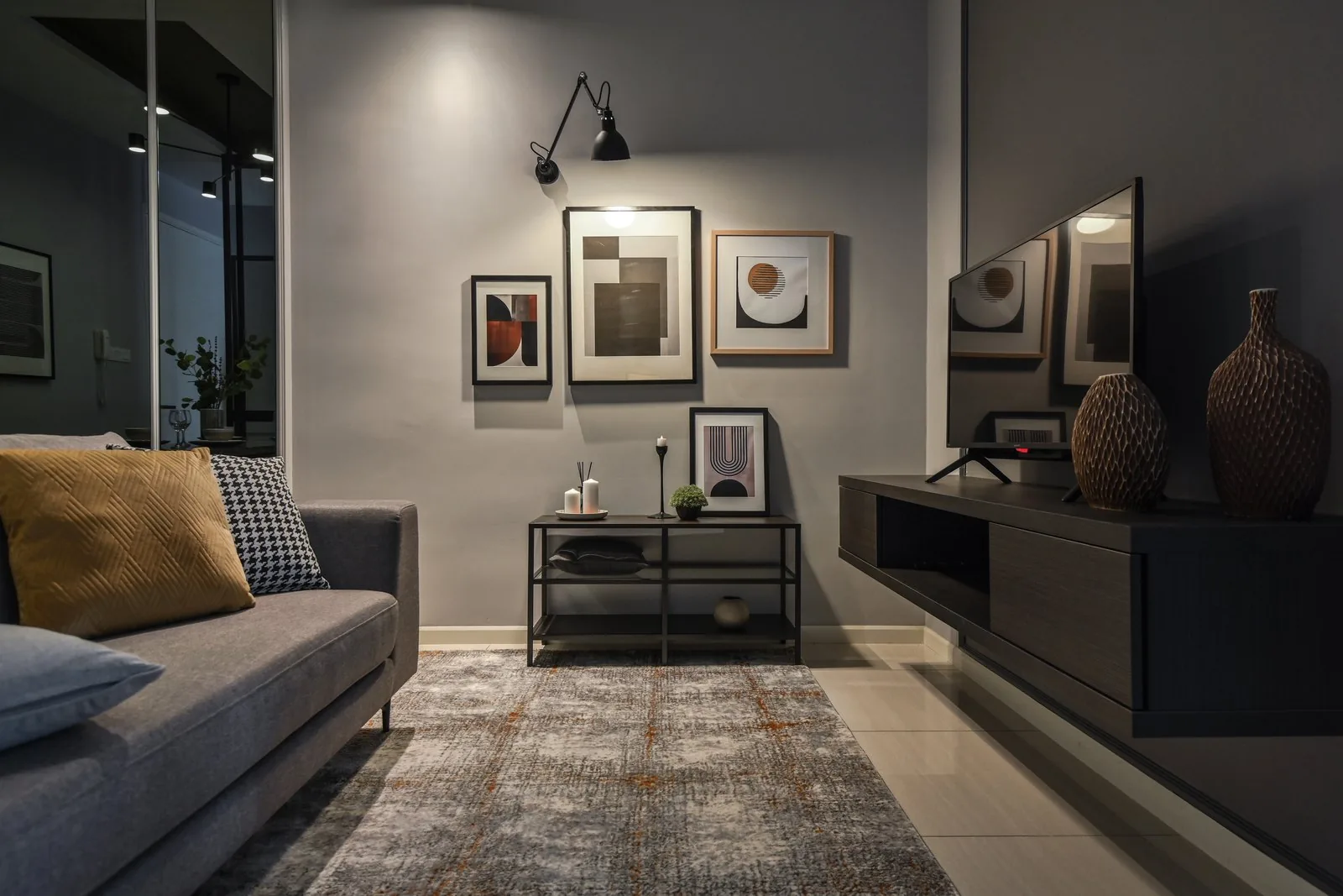 Wall mounted TV above a floating console in the condo living room of the Dorsett Hartamas show unit