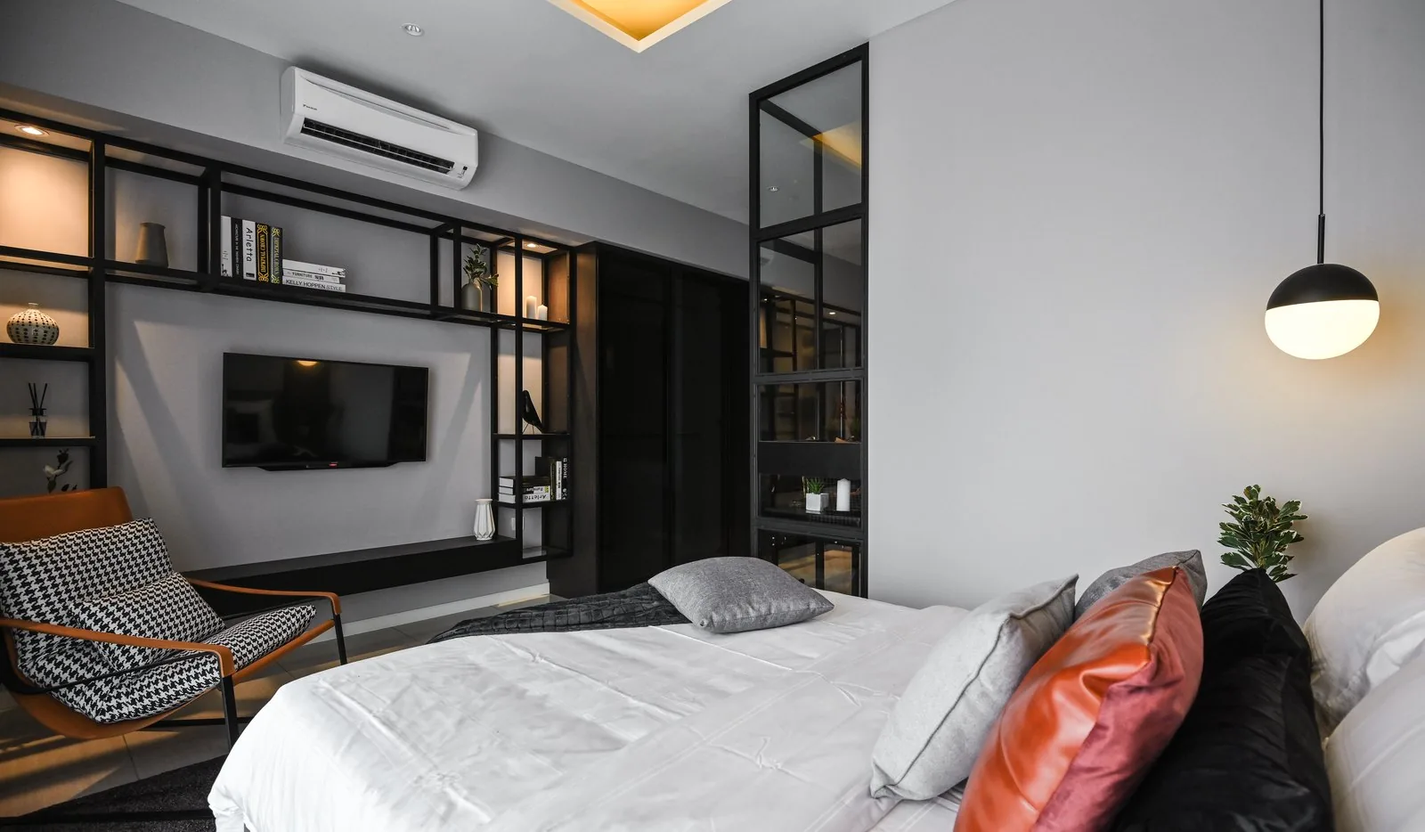 Bedroom TV wall inside a black shelving frame in the Dorsett Hartamas show unit