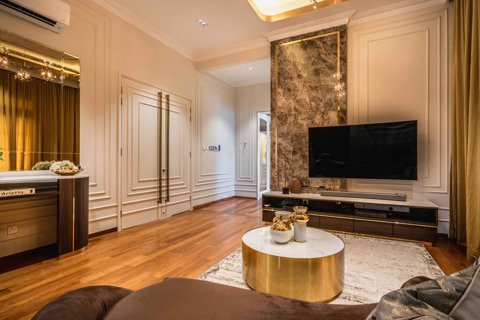 Master bedroom lounge with a marble TV panel and TV console at EcoSpring