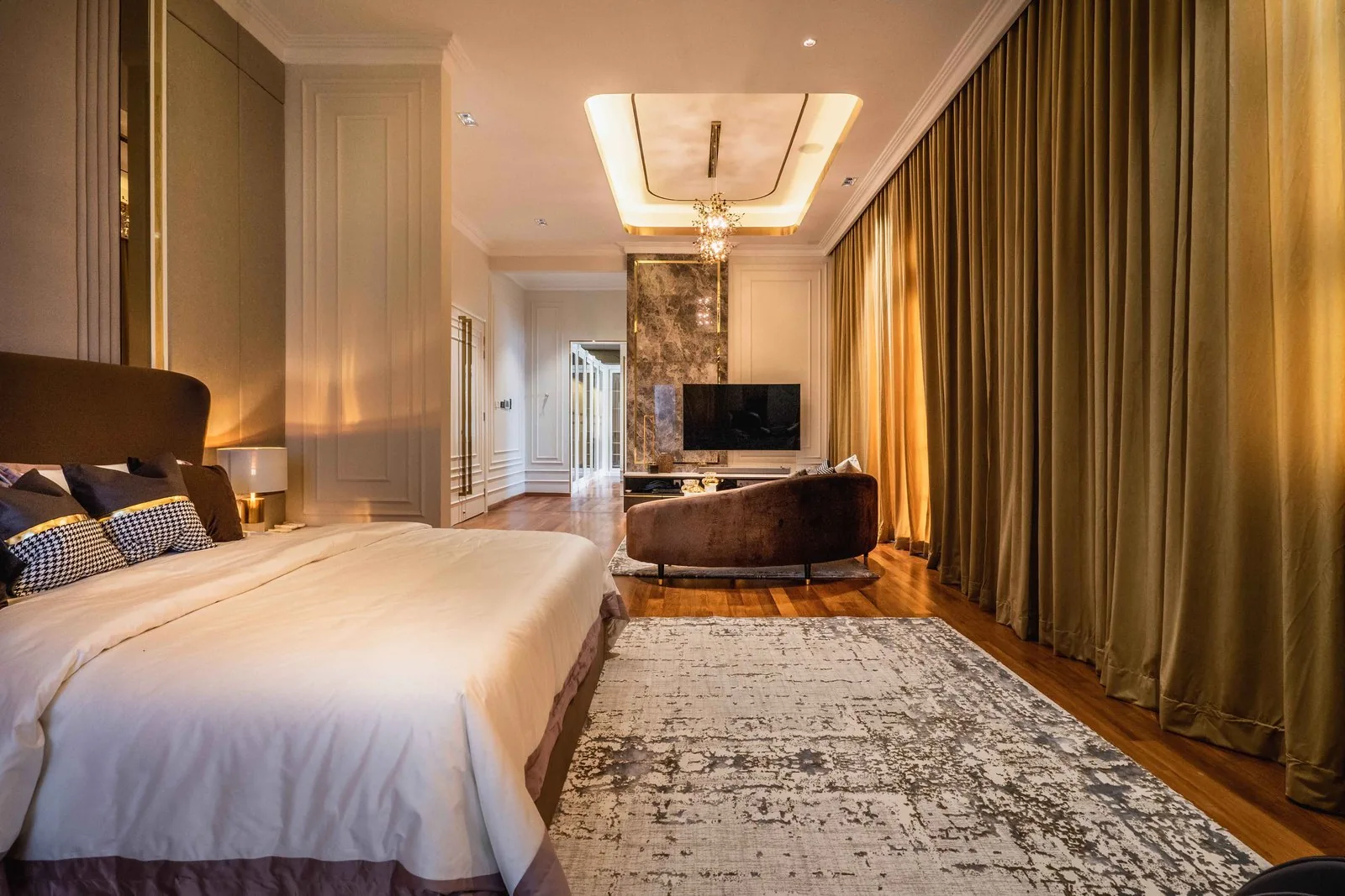 Bedroom suite with a TV wall and lounge seating at EcoSpring