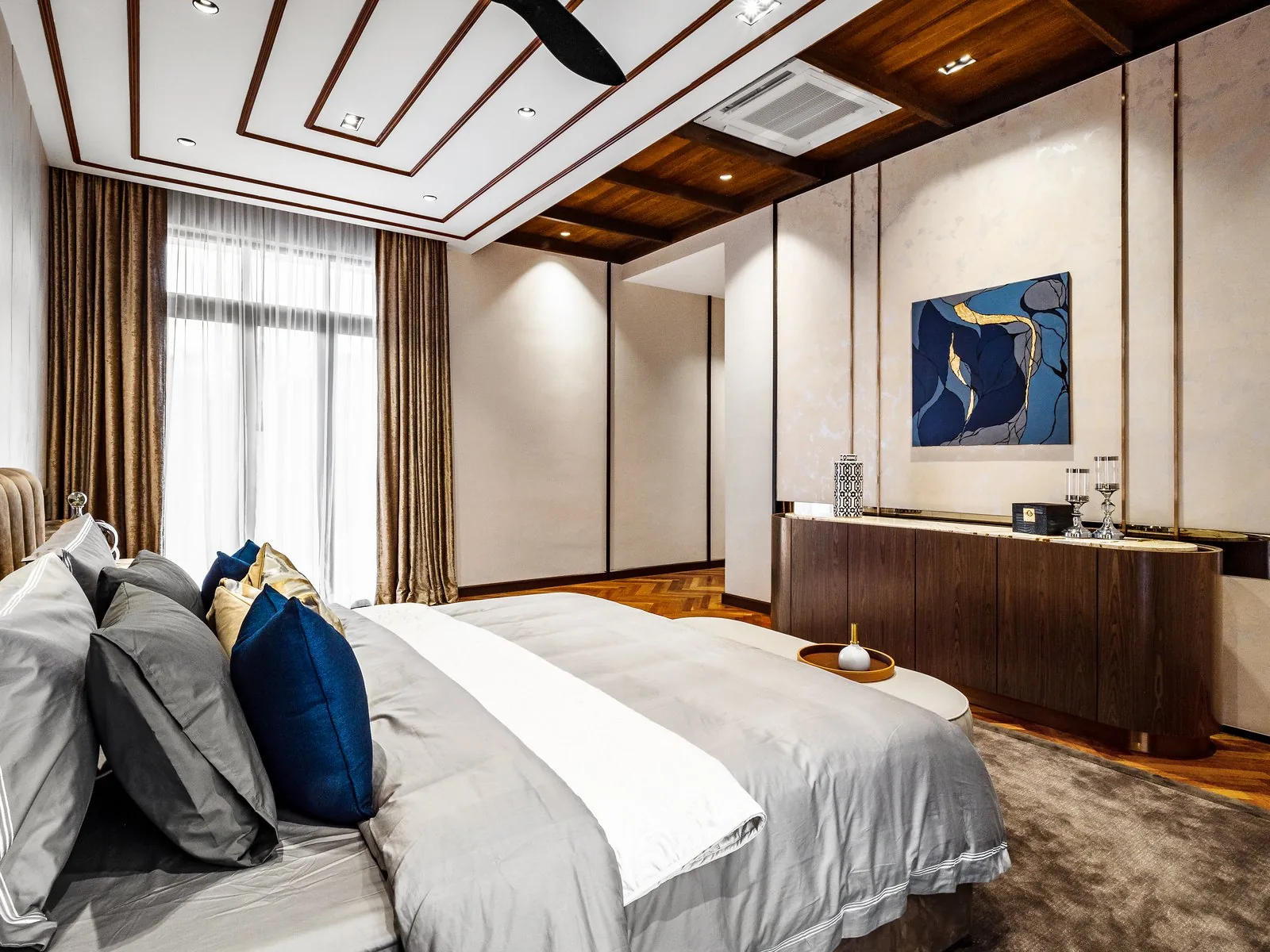Bedroom with a low timber TV console in the Terengganu bungalow