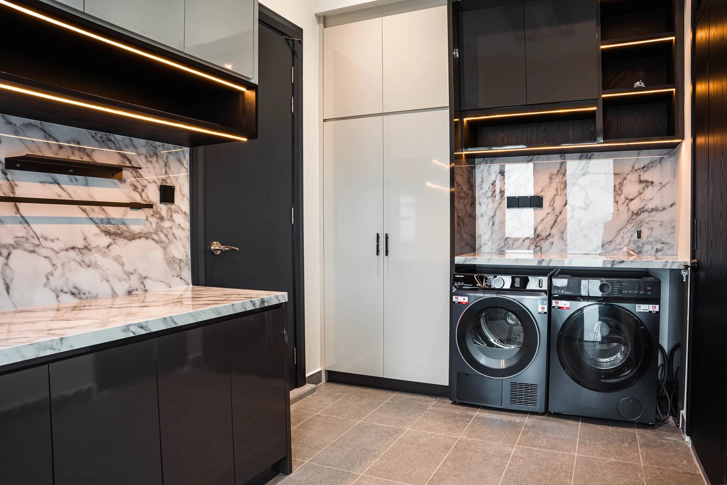 Utility room with gloss cabinetry, open shelving and integrated laundry appliances at Setia Marina One, Cyberjaya, by Blaine Robert Design