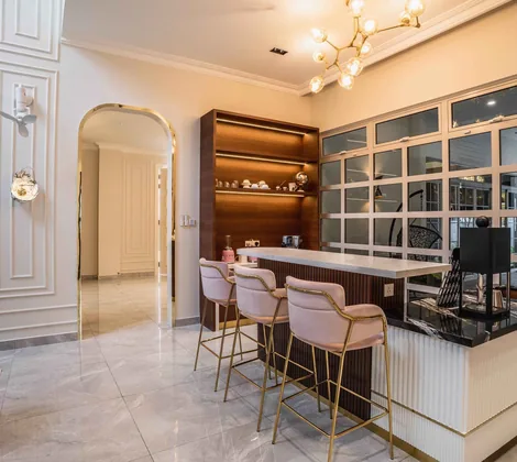 Dining room with full-height classical wainscoting panels, brass-framed art and a bar counter at EcoSpring, Johor Bahru