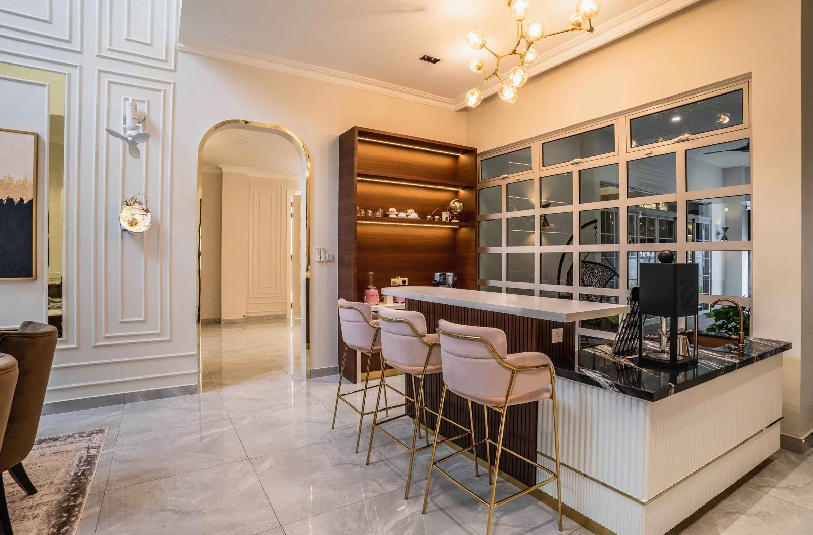 Dining room with full-height classical wainscoting panels, brass-framed art and a bar counter at EcoSpring, Johor Bahru