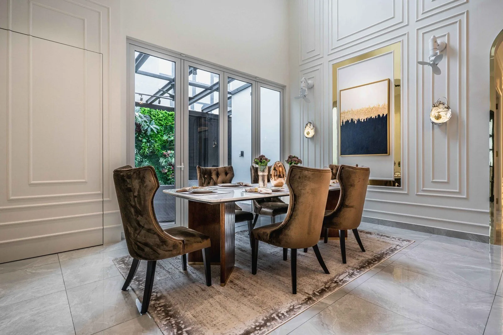 Full-height wainscoting panels in a double-volume dining room at EcoSpring, Johor Bahru
