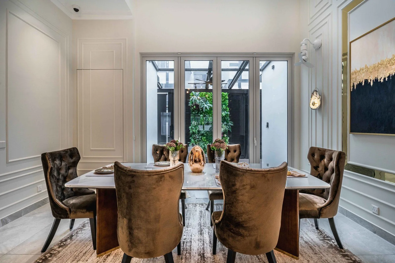 Dining room with classical wainscoting panels and doors to a garden at EcoSpring
