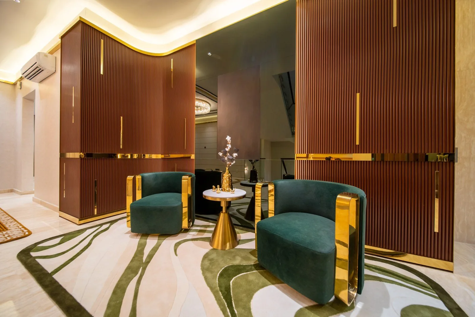 Living area with fluted timber panels and gold trim at a Bangsar bungalow