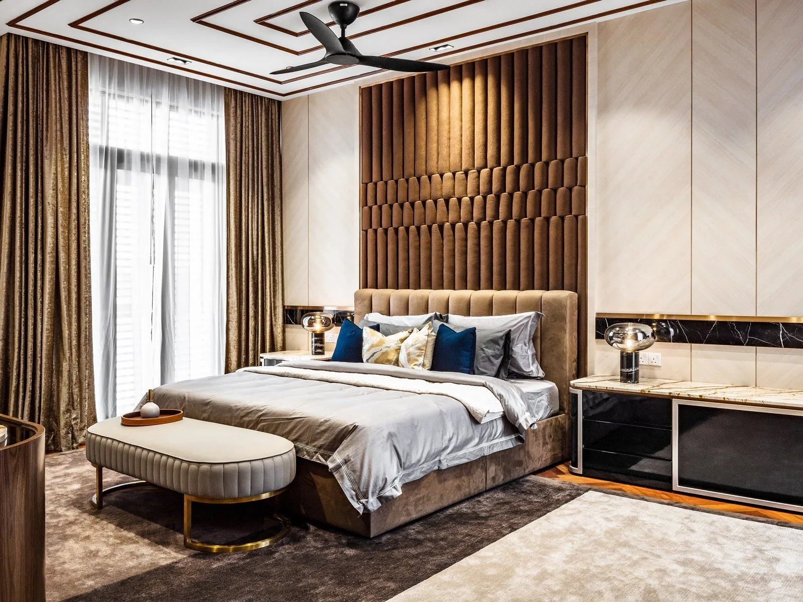 Full-height upholstered headboard wall beside herringbone wood paneling at the East Coast Villa, Terengganu