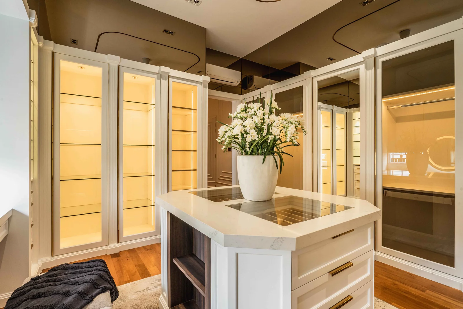Central island with drawers inside a walk in wardrobe, Eco Spring bungalow, Blaine Robert Design