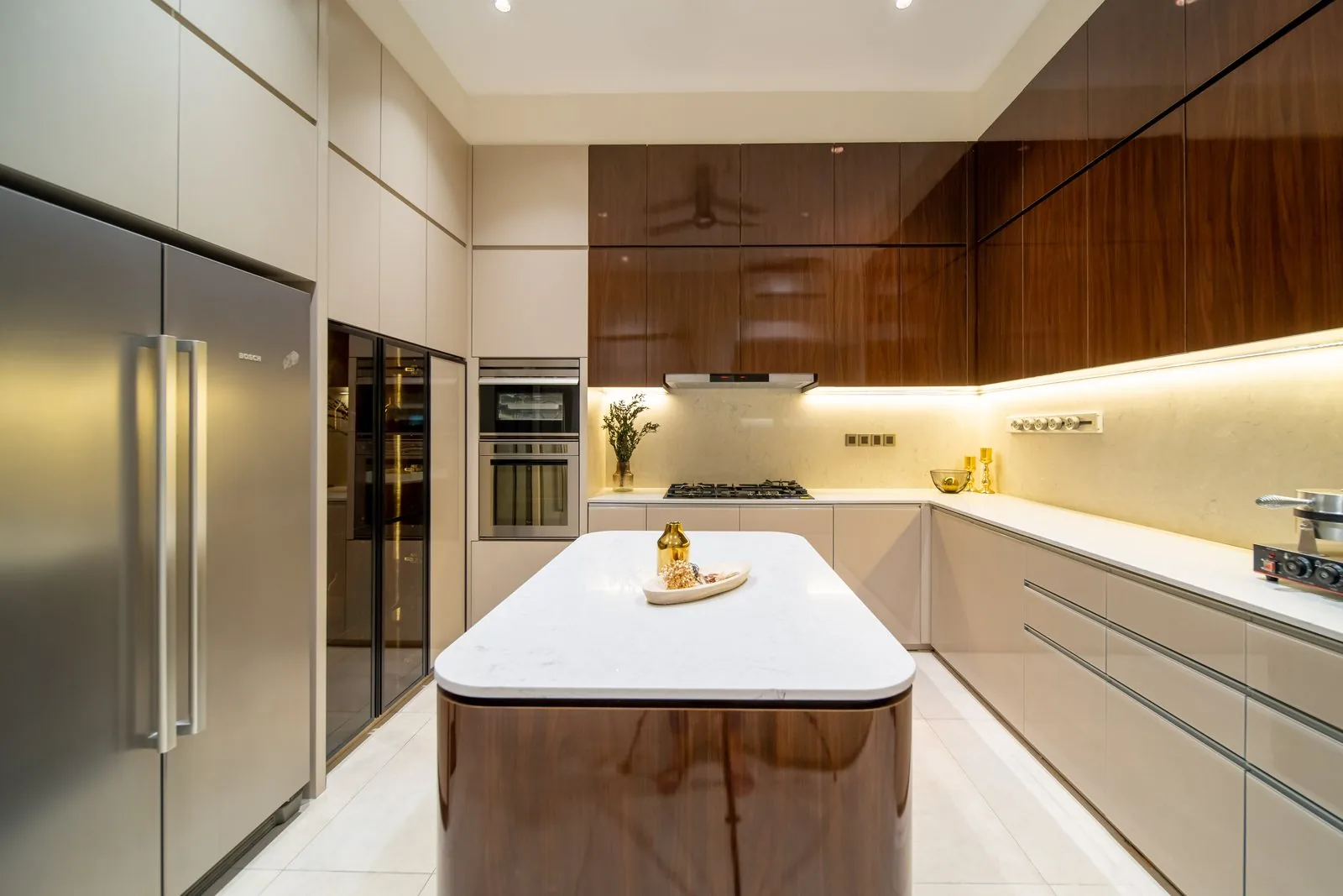 Wet kitchen with white cabinets, timber accents and a full-height refrigerator in a Bangsar bungalow