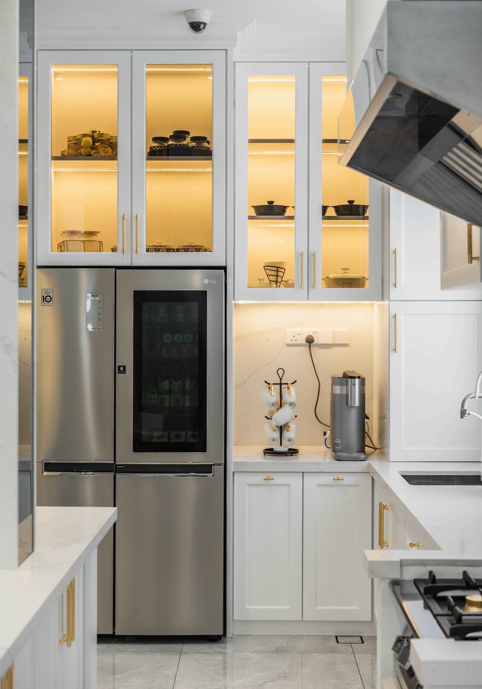 Wet kitchen with glass-front cabinets in a Malaysian landed home